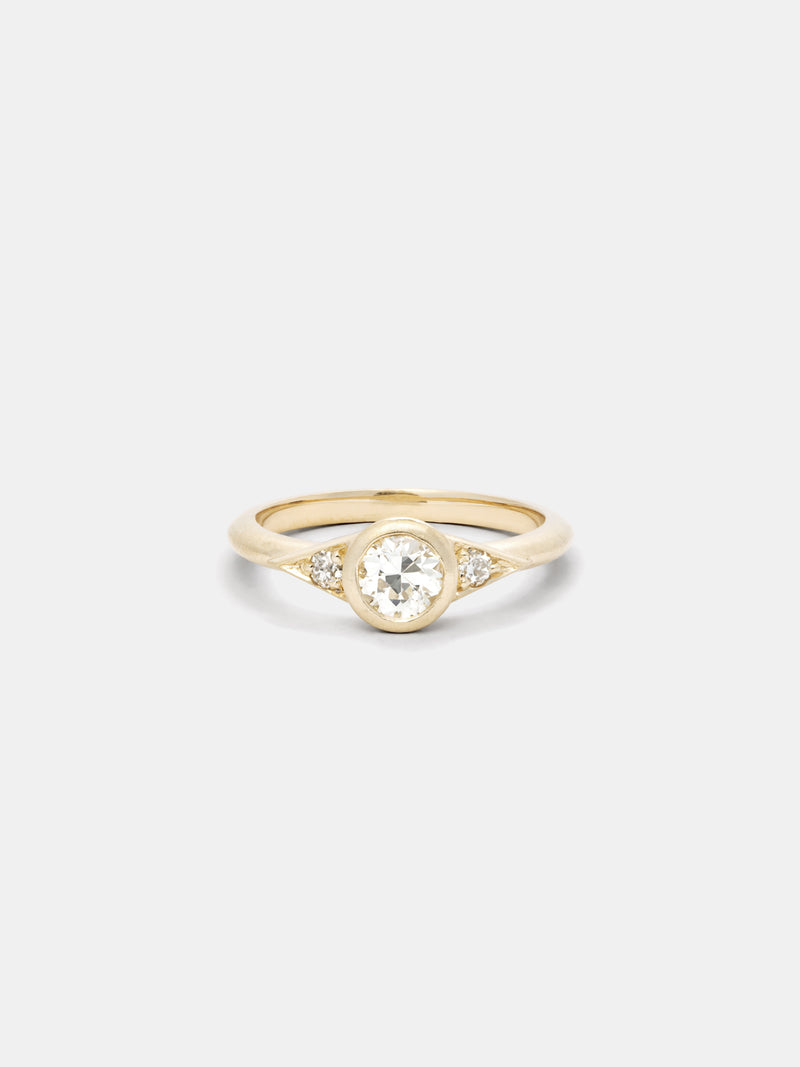 Shown: 0.5ct Faint Color center stone with 2mm side stones in 14k yellow gold with smooth texture and signature matte finish.