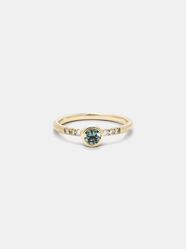 Shown: 0.25ct aqua Montana Sapphire with pave diamonds in 14k yellow gold with smooth texture and signature matte finish.