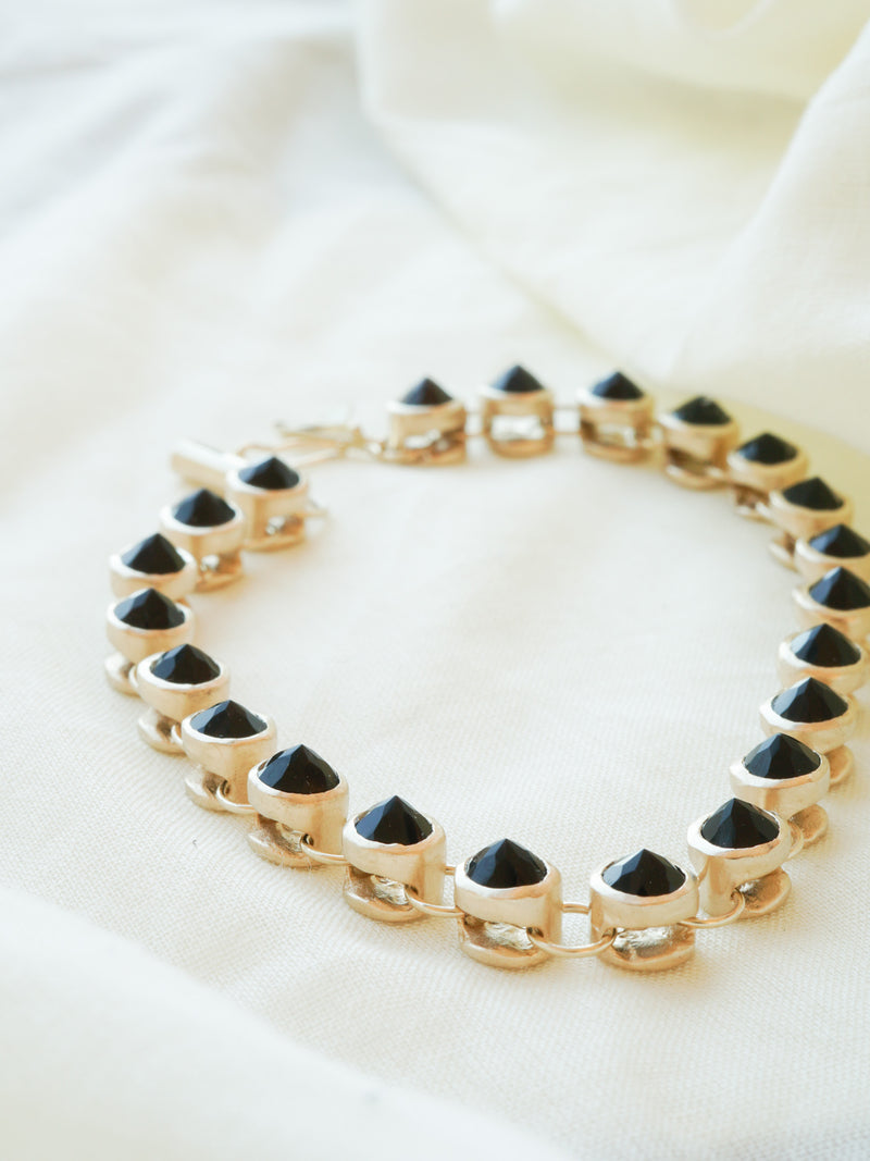 Shown: 14k yellow gold and black spinel with a matte finish